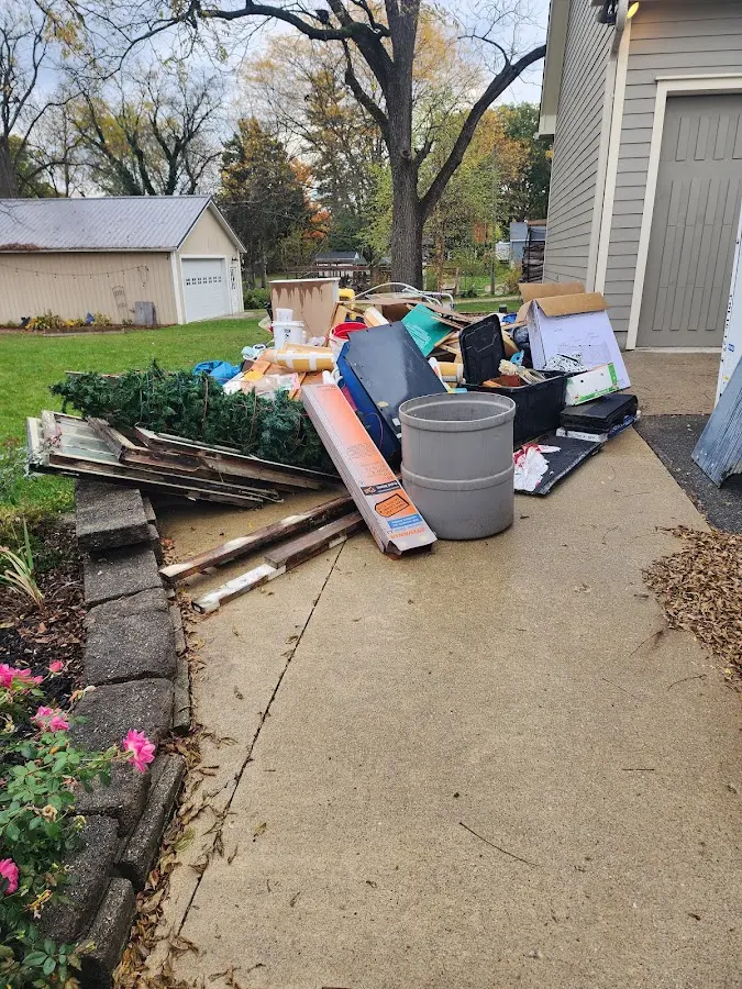 Dumpster being loaded with debris for 3 Yard Dumpster Rental in Fort Scott